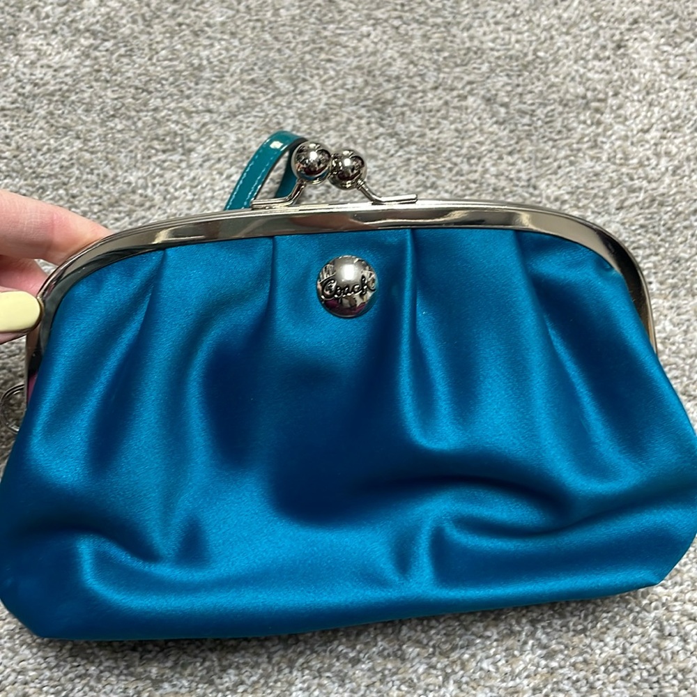 Satin teal Coach wristlet with snap closure